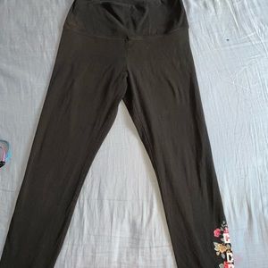 black leggings with pink flowers on one of the legs!